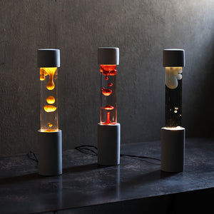点灯すると呼吸をするように流動的に形を変えながらコンクリートの筒を行き来する Dripping Lamp（ドリッピングランプ）